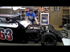 English guy Playing with a Dirt Modified Race car in Texas, in the shop.
